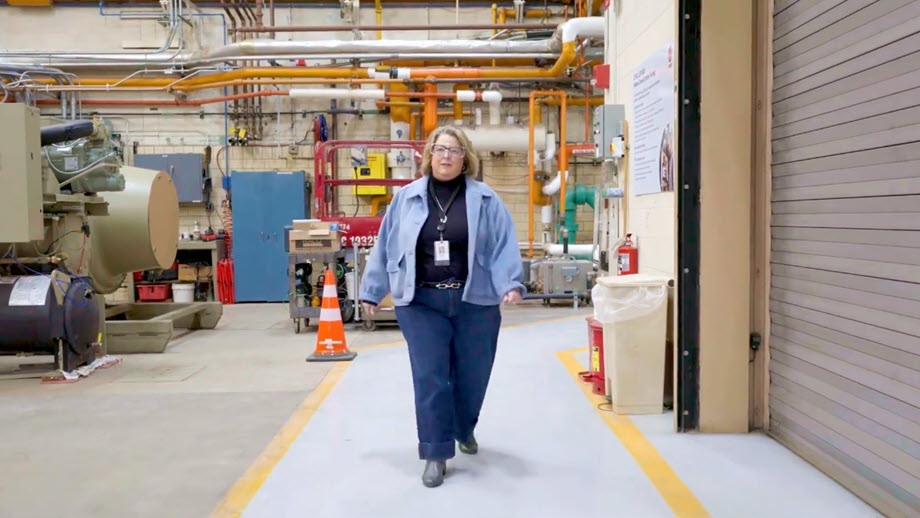 woman walking in factory setting