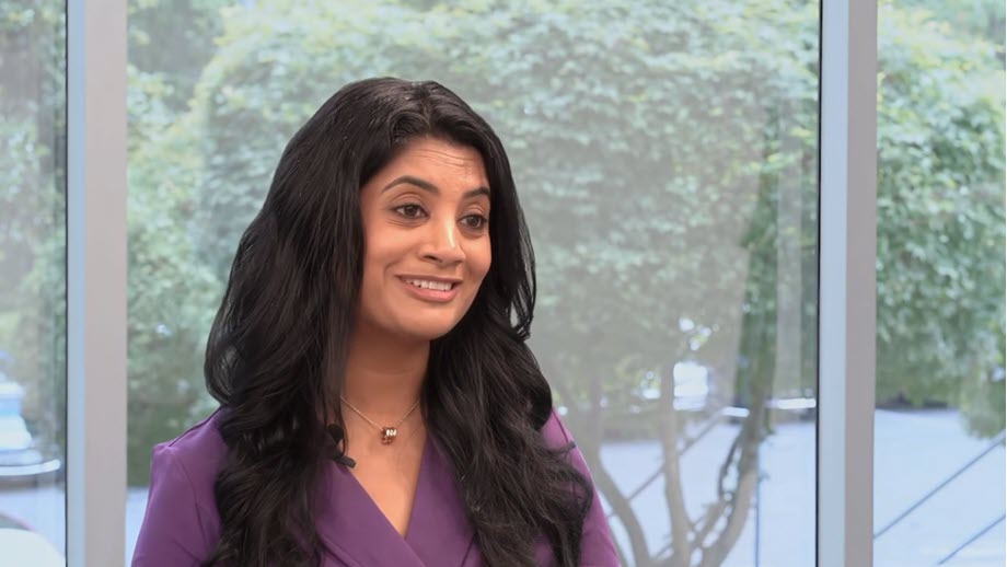 Sashi smiling for interview in office setting
