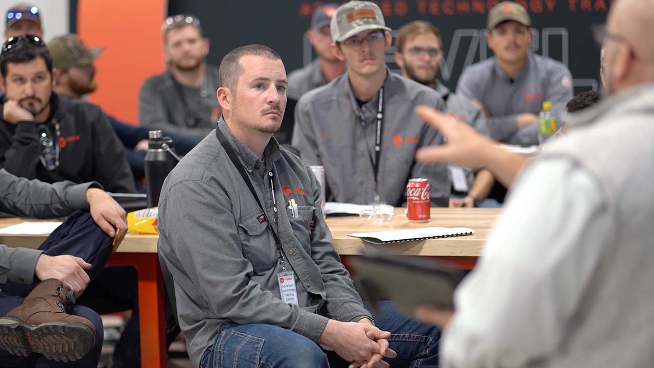technicians listen attentively during training session