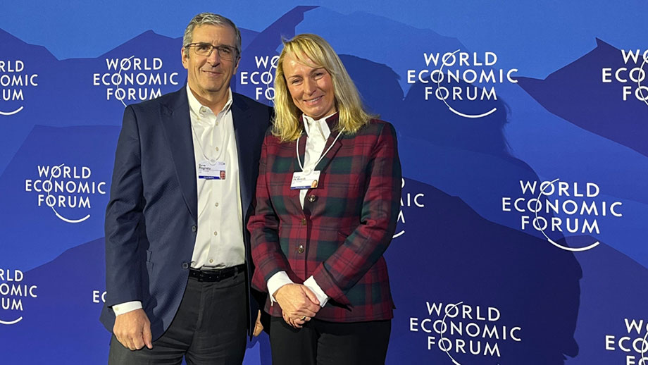 Dave Regnery and Karin De Bondt standing in front of the World Economic Forum backdrop at Davos 2026